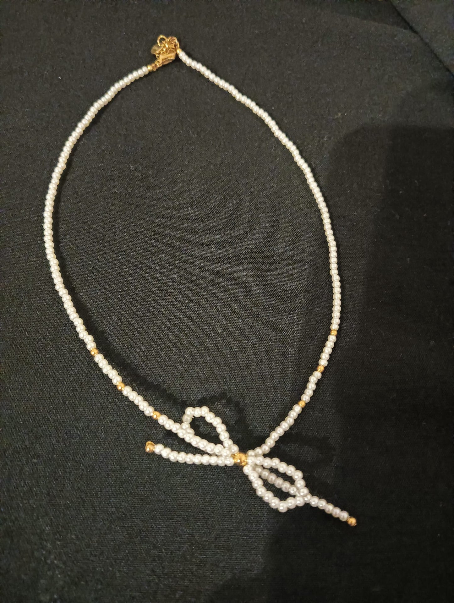Collana fiocco con perline bianche e dorate